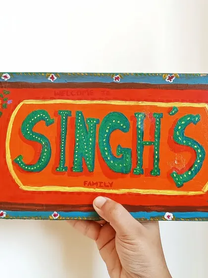 Welcome guests to your home with a personalized name plate. For this piece, I used a bright, folk-art inspired design to create a warm and inviting entrance sign for the Singh family.