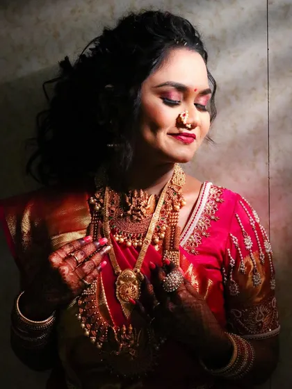 A serene and beautiful portrait of the bride with her eyes closed, highlighting the flawless makeup and her peaceful expression.