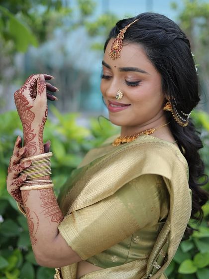 A beautiful shot showcasing her intricate henna and the soft, natural makeup. The look is all about enhancing her features and creating a flawless, long-lasting finish.