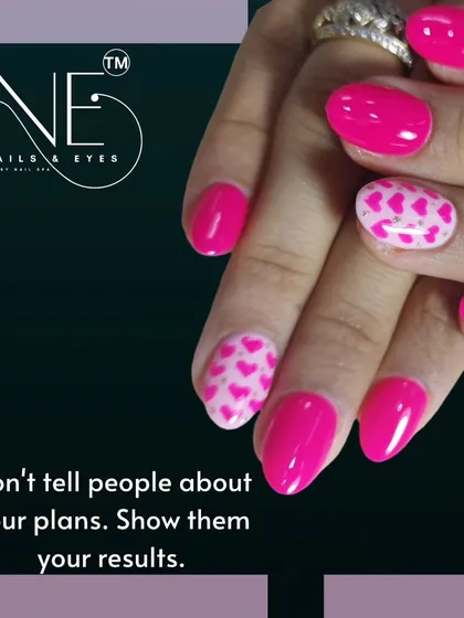 "Don't tell people about your plans. Show them your results." This bold pink manicure with a heart-patterned accent nail speaks for itself.