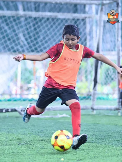 A player strikes the ball with power and precision, a skill honed during our dedicated training sessions.