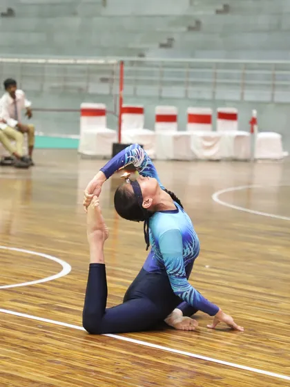 Another talented gymnast demonstrates her skill on the floor during the National Sports Day event. Our versatile wooden court is suitable for gymnastics and dance performances.