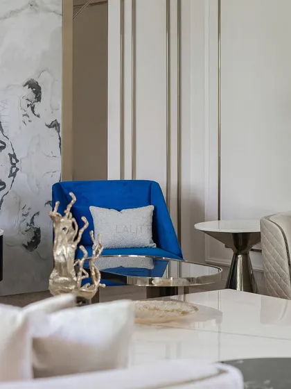 This detail shot shows the sculptural gold decor piece and the elegant side table, demonstrating how we layer accessories to add personality and refinement to our projects.