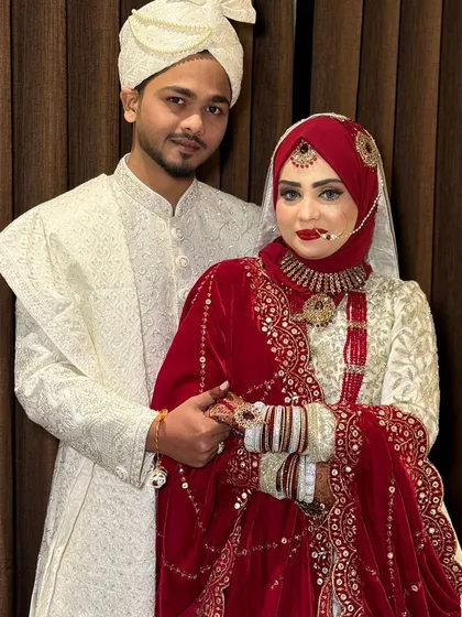 Another shot of this beautiful couple. The bride's red hijab and matching lip create a classic and timeless bridal look.