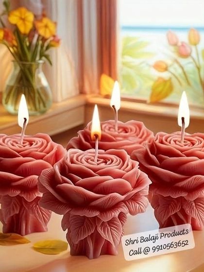 A stunning display of four lit rose pillar candles. These make for a beautiful and elegant decoration for any home or event.