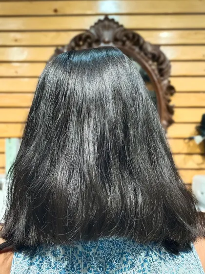 The "before" photo, showing the client's natural dark hair.