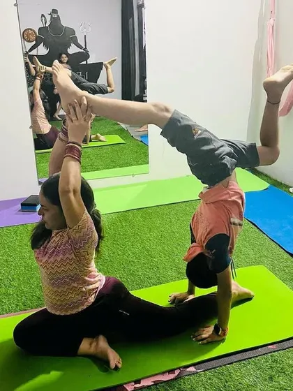 A creative combination of a pigeon pose for the base and a handstand with a backbend for the flyer. Acro yoga lets us explore fun new shapes and challenge our bodies in different ways.
