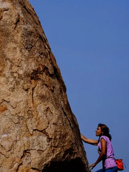 A closer look at a climber sizing up a boulder problem. Outdoor climbing is a puzzle of movement, and we love figuring it out together.