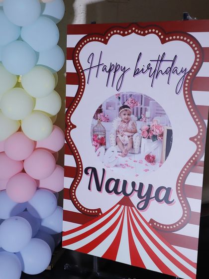 A circus-themed welcome sign for Navya's first birthday party.