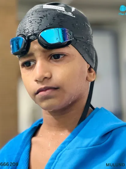 The tense moment before the results are announced. This young swimmer reflects on his performance after a challenging race.