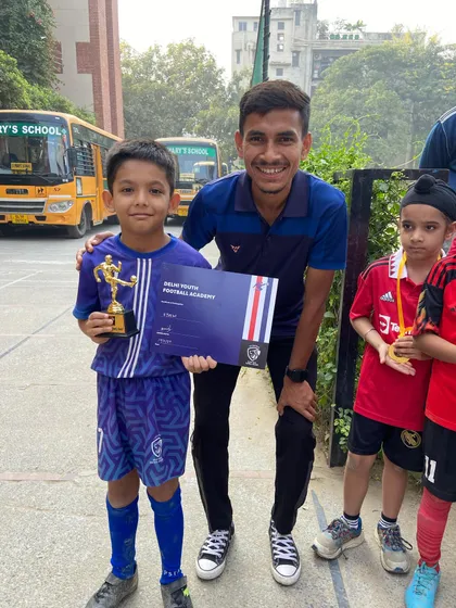 Mukund, our Best Goalkeeper, with his trophy. We provide specialized training for every position on the field.