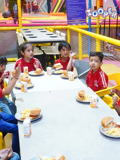 When the jumps make you hungry, we’ve got the yummiest fix. A group of school kids enjoys a well-deserved meal of burgers and fries.