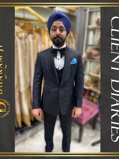 A client looking dapper in a custom-fitted black three-piece tuxedo with a bow tie and a blue pocket square. The perfect fit is evident.