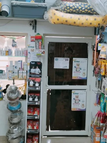 A view of the shop showing the wide range of products available, from feeding bowls and grooming supplies to treats hanging on the wall.