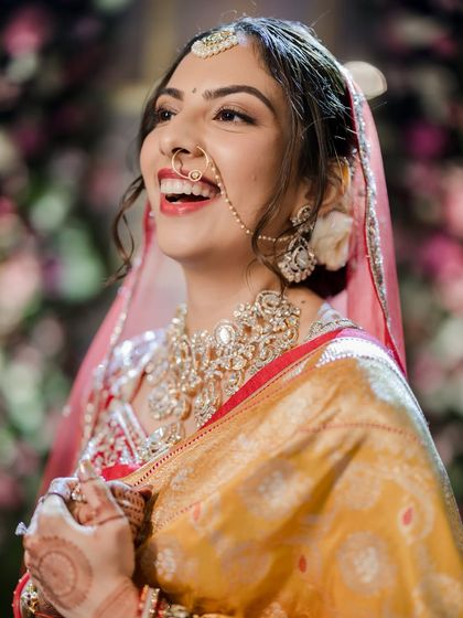 A candid shot full of laughter and joy. This is what it's all about: creating a look that makes the bride feel comfortable, confident, and beautiful.