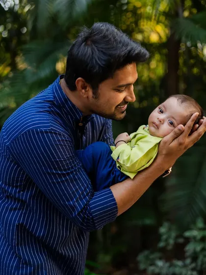 A father's gentle hold. I focus on capturing the tender connection between parents and their new baby, showcasing the love and pride of this important family milestone.