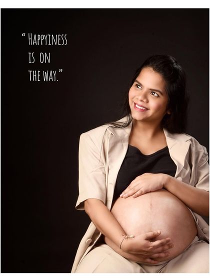 "Happiness is on the way." This portrait combines a beautiful, natural pose showing the baby bump with a simple quote, perfectly capturing the feeling of this special time.