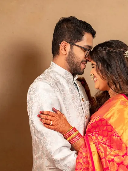 An intimate pre-wedding portrait. The simple background and close framing put all the focus on the couple's happy connection.