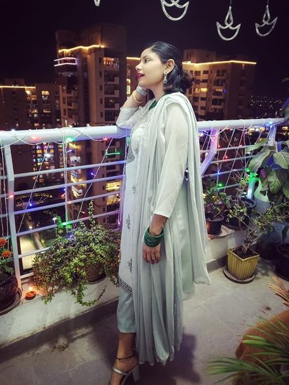 A serene Diwali moment on the balcony, overlooking the city lights. I chose a simple and elegant light green kurta set, which felt perfect for a quiet, festive evening at home.