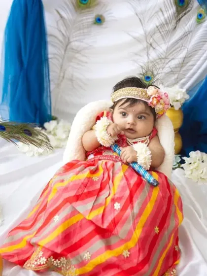 Holding a little flute, just like Krishna. It's these small details that bring the theme to life and create such authentic portraits.