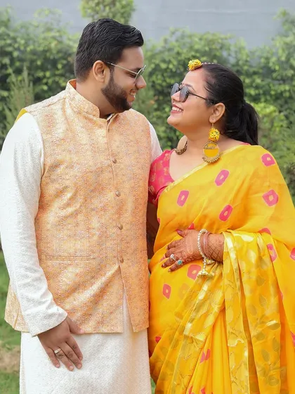 A sweet, candid moment between a couple at their Haldi ceremony, sharing a look of love.