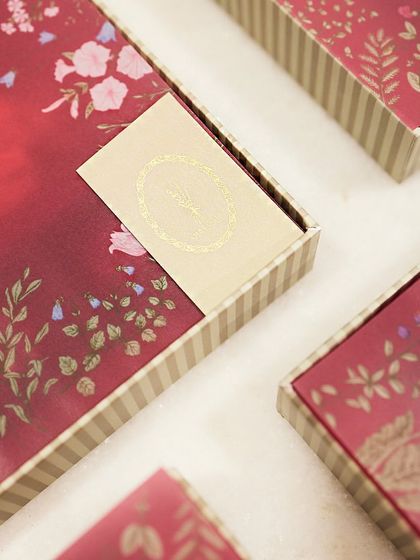 Hosting a special event? These custom red and gold floral boxes were designed for a corporate client's festive gifting needs.