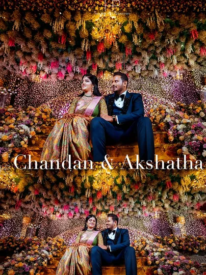 A stunning reception portrait of Chandan and Akshatha seated on a grand staircase completely covered in flowers. This shot combines elegant posing with breathtaking decor to create a truly memorable image.