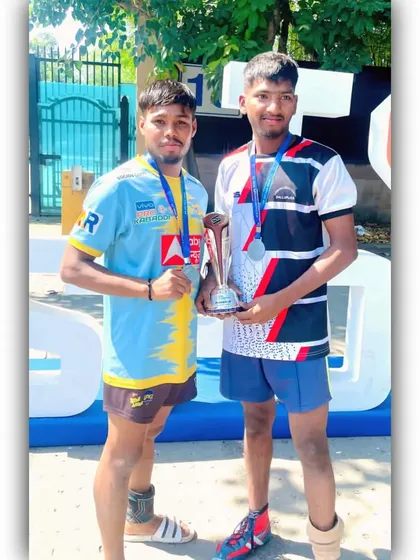 Two of our academy players showing off their medals and trophy.