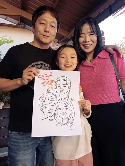 A beautiful Korean family with their group caricature, captioned "Smile in India". It was a pleasure creating this special souvenir for their trip.