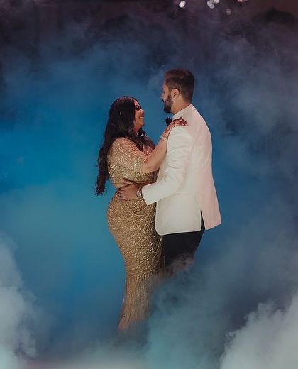 A magical first dance moment, with the couple surrounded by ethereal blue fog. This shot highlights how lighting and effects can elevate a simple dance into a spectacular one.
