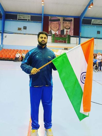 Our coaching team also represents India. Here is Dr. Naazim Khan holding the Indian flag at the Al Watani Amman Table Tennis Championship in Jordan.