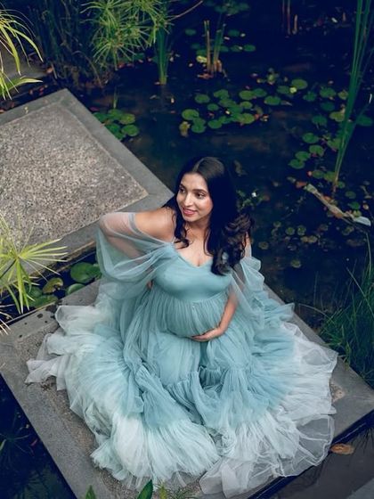 An aerial view of our Winter gown in a lush, green setting. The layers of tulle spread out beautifully, resembling a water lily in a pond.