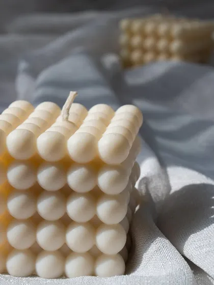 A close-up of our bubble candle, with beautiful light and shadow play on its surface. It's a simple yet stunning piece.