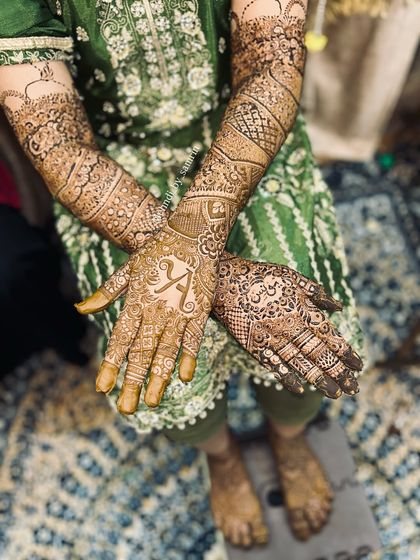 A lovely candid shot of the bride's full mehendi. The design includes the groom's initial "A" for a personal touch.
