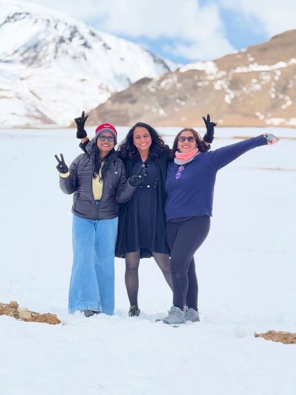 Three friends celebrating their journey through the snowy landscapes of Ladakh. I help create the perfect trip for your small group to bond and explore.