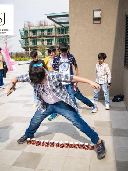 A classic can-knockdown game in progress. We bring all the fun of the fair to your party with a range of engaging game stalls.