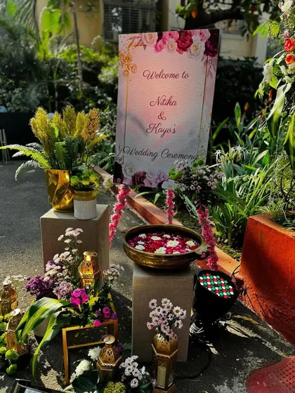 A beautiful welcome setup for a wedding ceremony. I used a custom sign, floral arrangements, and traditional brass lamps to greet guests as they arrive.