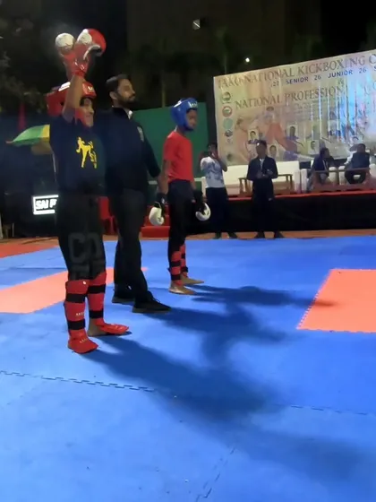 The referee raises the hand of our gold medalist, a proud moment for the whole team.