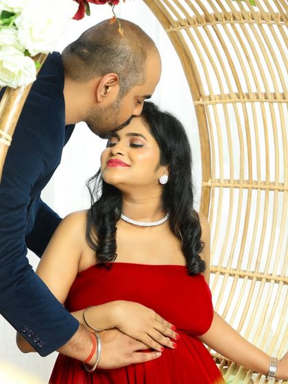 Using our studio's unique props, like this hanging rattan chair, adds a touch of elegance and charm to this romantic couple's portrait.