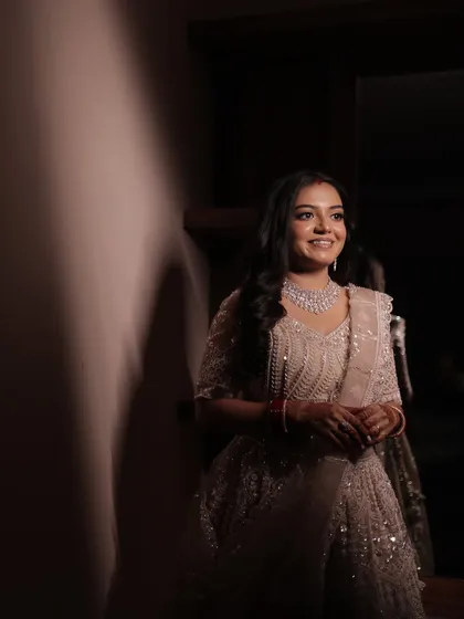 A stunning portrait of the bride, her reception makeup looking sophisticated and elegant in soft lighting.