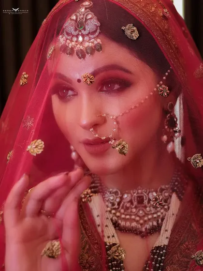 A dramatic close-up with a red veil, creating a moody and artistic portrait.