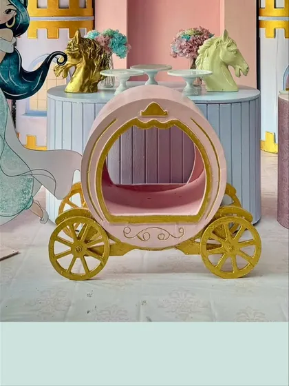 A detailed shot of the pink and gold pumpkin carriage, a perfect prop for any Cinderella or princess-themed party.