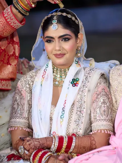 My beautiful bride Disha, ready for her Pheras. She looked like a dream in her white and pink lehenga. The makeup was kept soft and romantic, with pink tones on the eyes and cheeks to create a cohesive, angelic look.