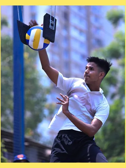 A player makes contact with the ball on the spike trainer, a perfect snapshot of power and precision.
