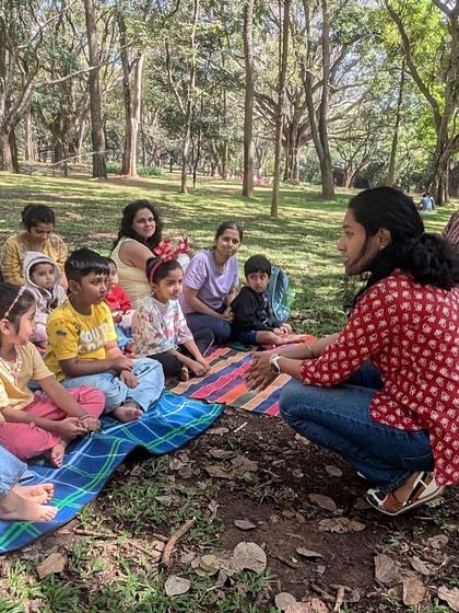 Getting down to the children's level to make the story more personal and engaging. This close interaction helps even the youngest listeners feel connected to the narrative and the characters.