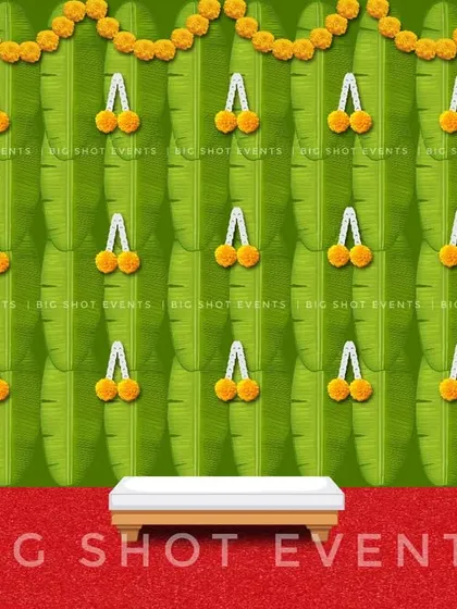 A simplified version of our banana leaf backdrop concept. This digital preview shows a clean green backdrop with marigold flower tassels, perfect for a variety of traditional ceremonies.