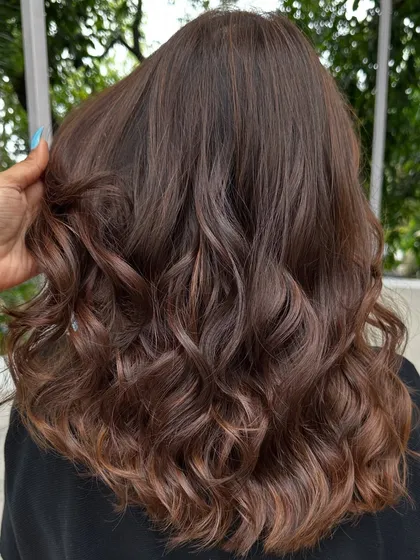 This 'Cinnamon Chocolate' color is perfect for adding warmth and spice to dark hair. The cinnamon tones really pop against the deep chocolate base, especially when styled with waves.