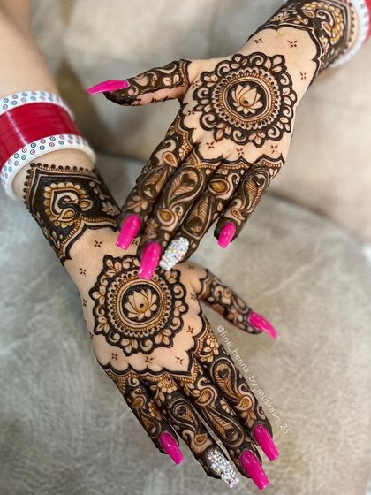 A beautiful Teej mehndi with a central lotus mandala. The mix of paisley and floral fillers gives it a very traditional look.