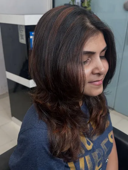 A side profile of the lovely copper brown highlights. You can see how the color frames her face and adds warmth to her overall look.