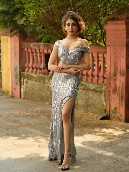 A full-length shot of the model in a silver sequin dress, captured on location. This demonstrates versatility beyond the studio.